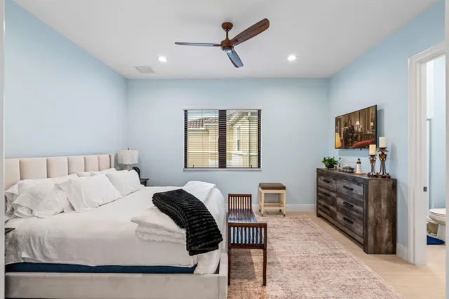 a bedroom with furniture and a flat screen tv