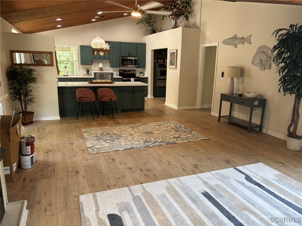 Living room featuring high vaulted ceiling, a ceil