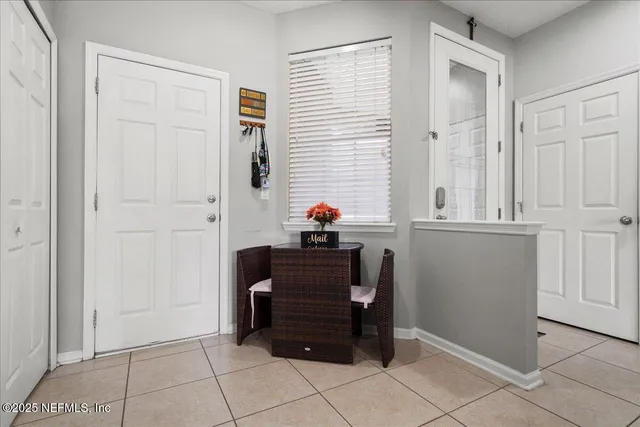a dining room with furniture and a window