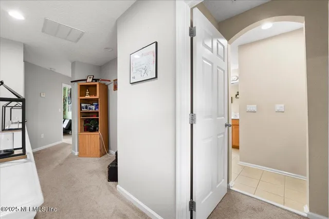 a view of a storage & utility room with refrigerator and toys