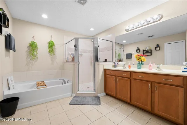 a spacious bathroom with a tub sink and mirror