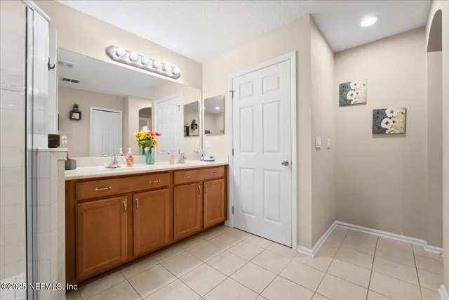 a spacious bathroom with a mirror a sink and a mirror