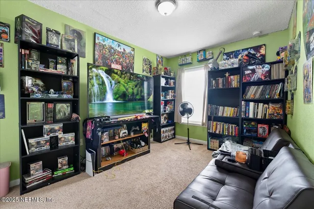 a living room with lots of furniture and a book shelf