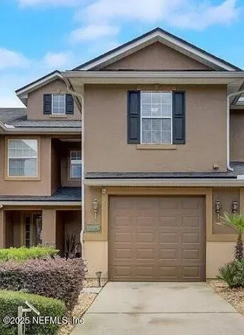 a front view of a house with garage