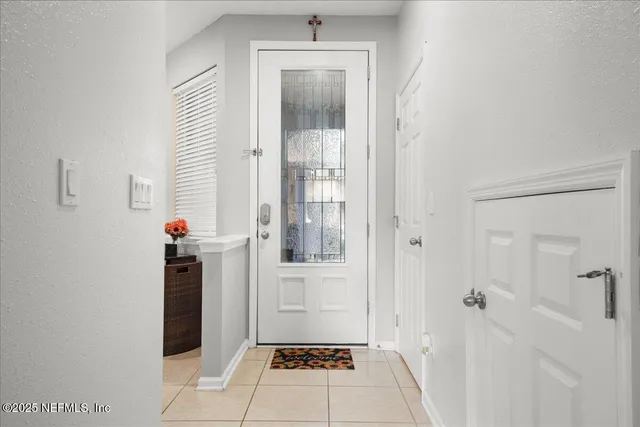 a view of a hallway with wooden floor and a bathroom
