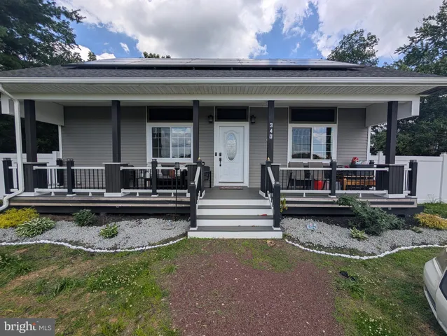 a view of a house with swimming pool and a chairs in a patio