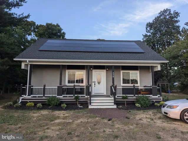 a view of a house with a yard porch and sitting area