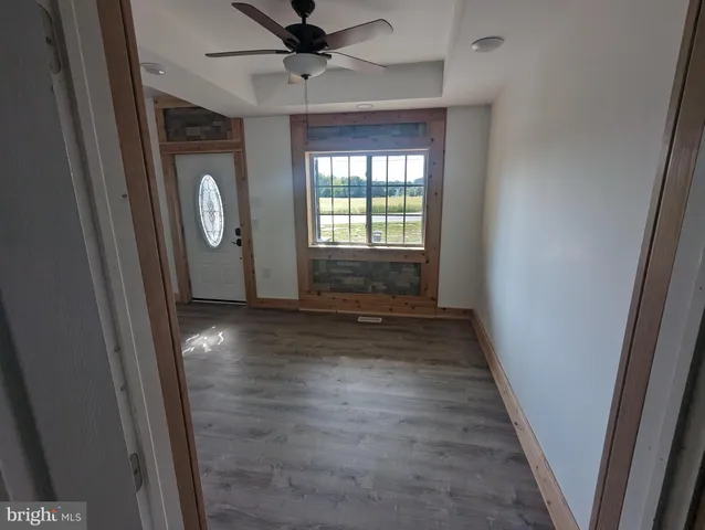 a view of a staircase with wooden floor and white walls