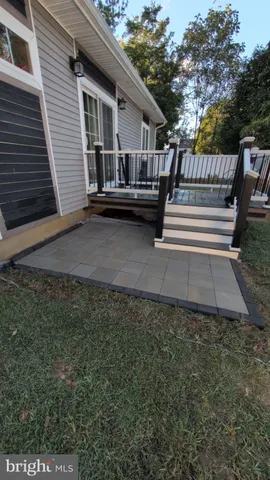 a view of a small yard in front of a house with wooden fence