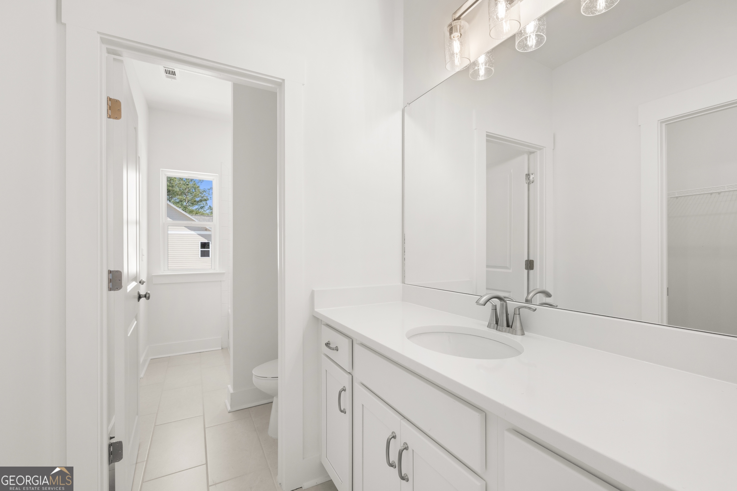 15 Overview Court Hoschton, GA 30548 - Photo 34 of 43 a bathroom with a sink vanity granite and a mirror