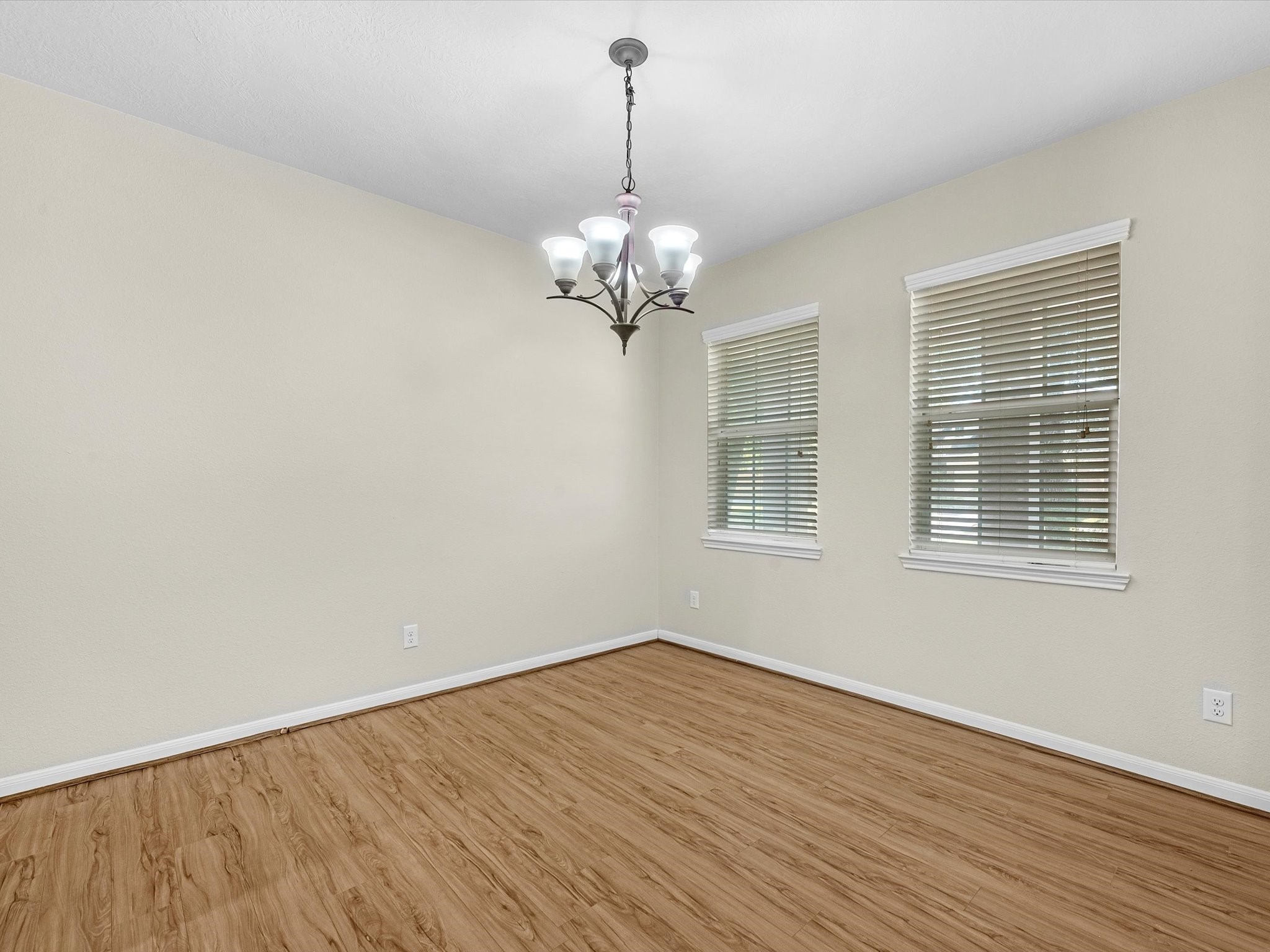 13307 Bomoseen Lake Road Houston, TX 77044 - Photo 18 of 40 a view of a room with wooden floor chandelier and windows