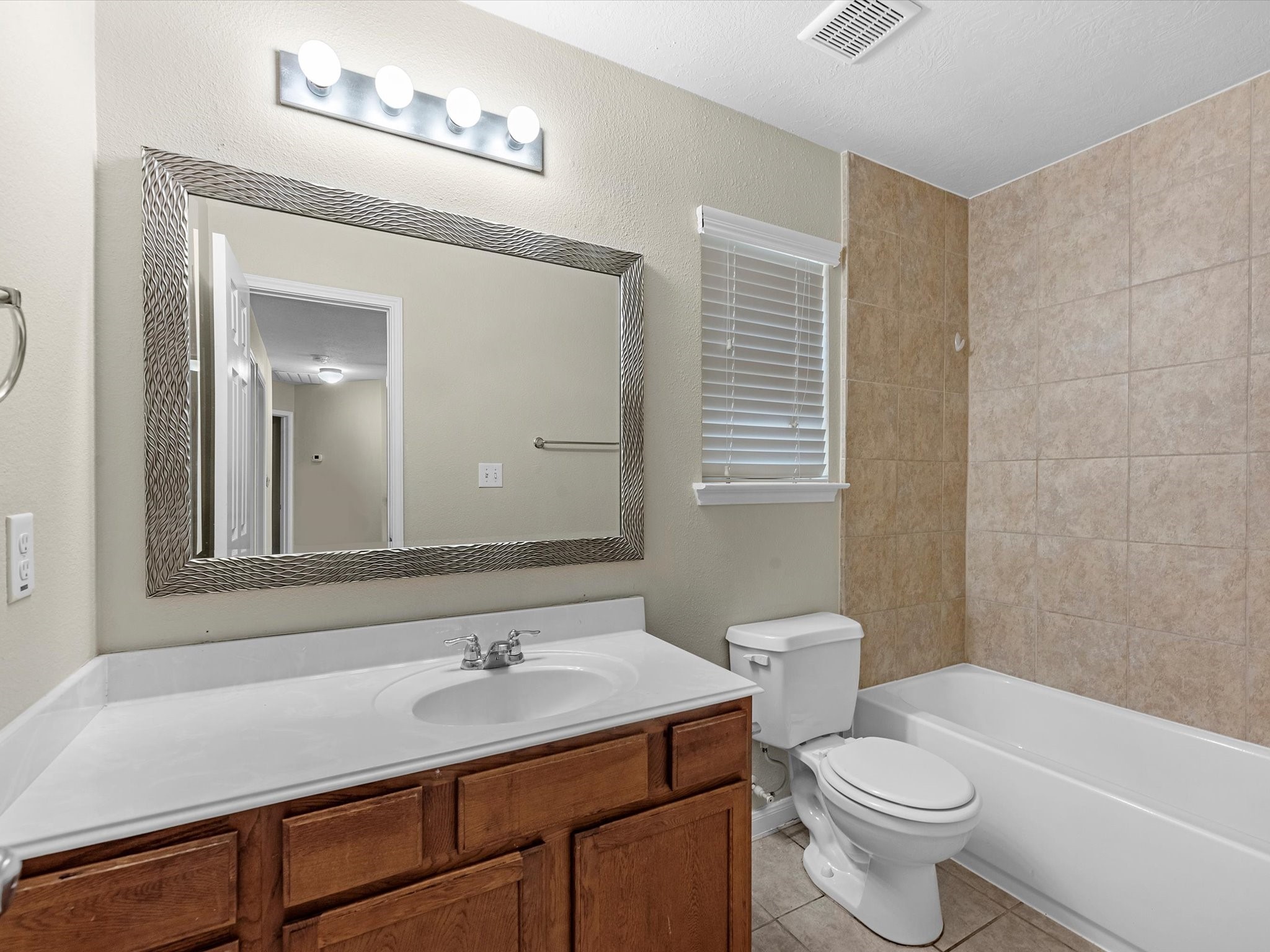 13307 Bomoseen Lake Road Houston, TX 77044 - Photo 29 of 40 a bathroom with a sink a toilet and a mirror