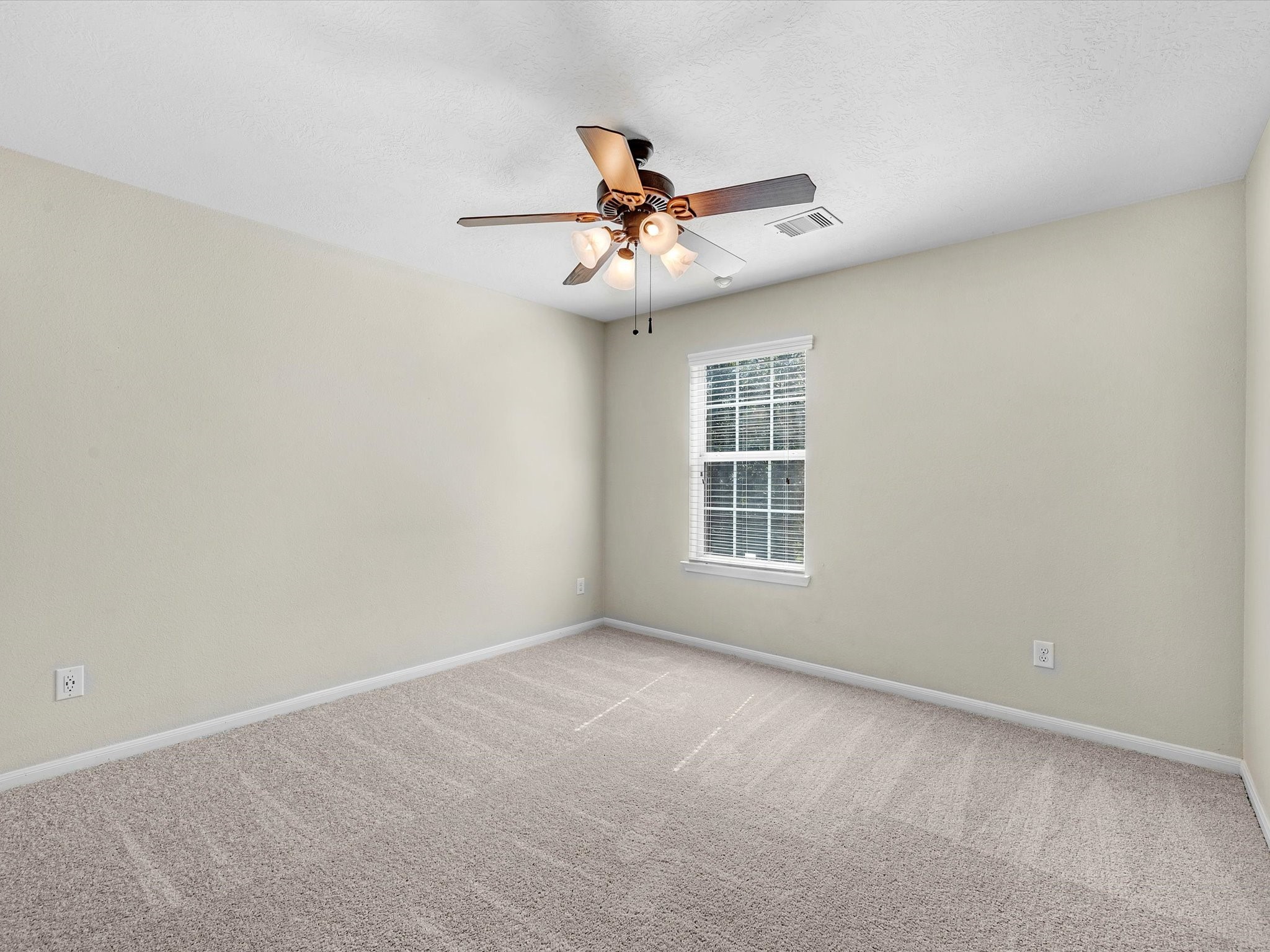 13307 Bomoseen Lake Road Houston, TX 77044 - Photo 31 of 40 an empty room with windows and fan