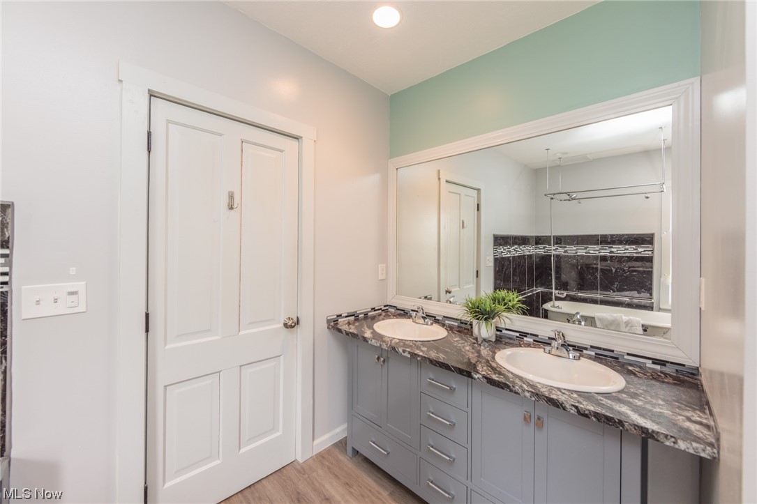 2551 Reimer Road Wadsworth, OH 44281 - Photo 10 of 35 Bathroom featuring a tub, dual vanity, and wood-type flooring