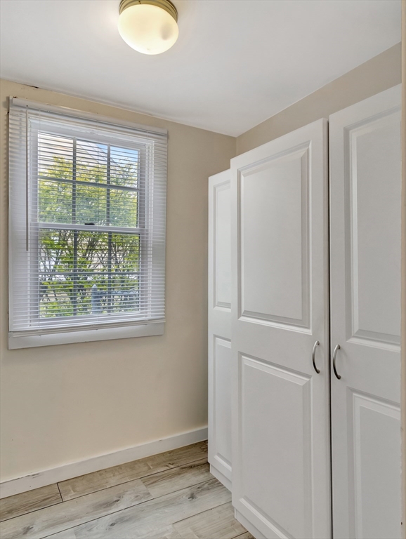 5 G Street Hull, MA 02045 - Photo 21 of 41 a view of an empty room with wooden floor and a window