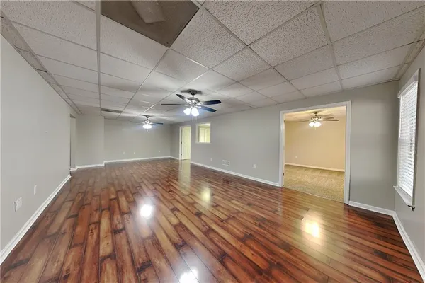 a view of empty room with wooden floor