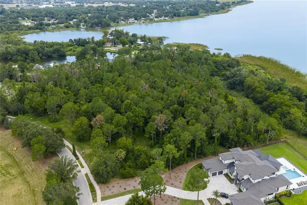 an aerial view of a houses with yard