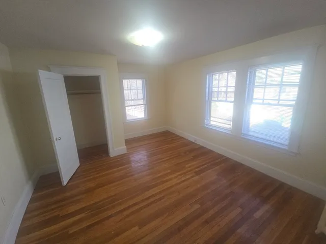 a white toilet sitting in a bathroom next to a sink