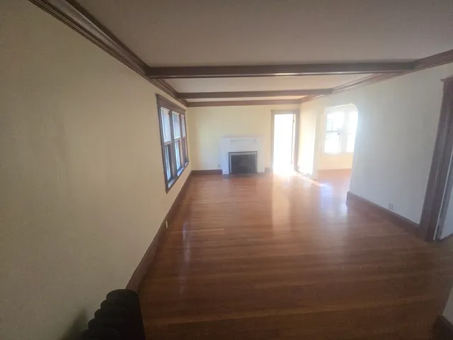 a dining room with furniture and wooden floor