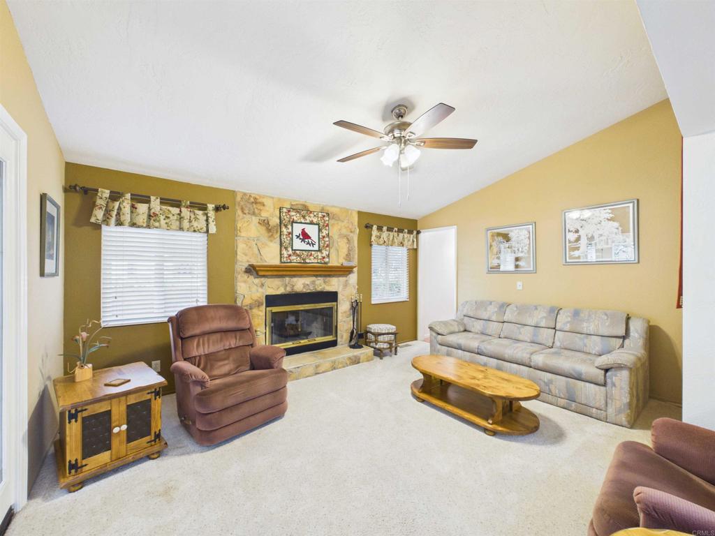 18218 Paradise Mountain Road, Unit 220 Valley Center, CA 92082 - Photo 28 of 48 a living room with furniture and a fireplace