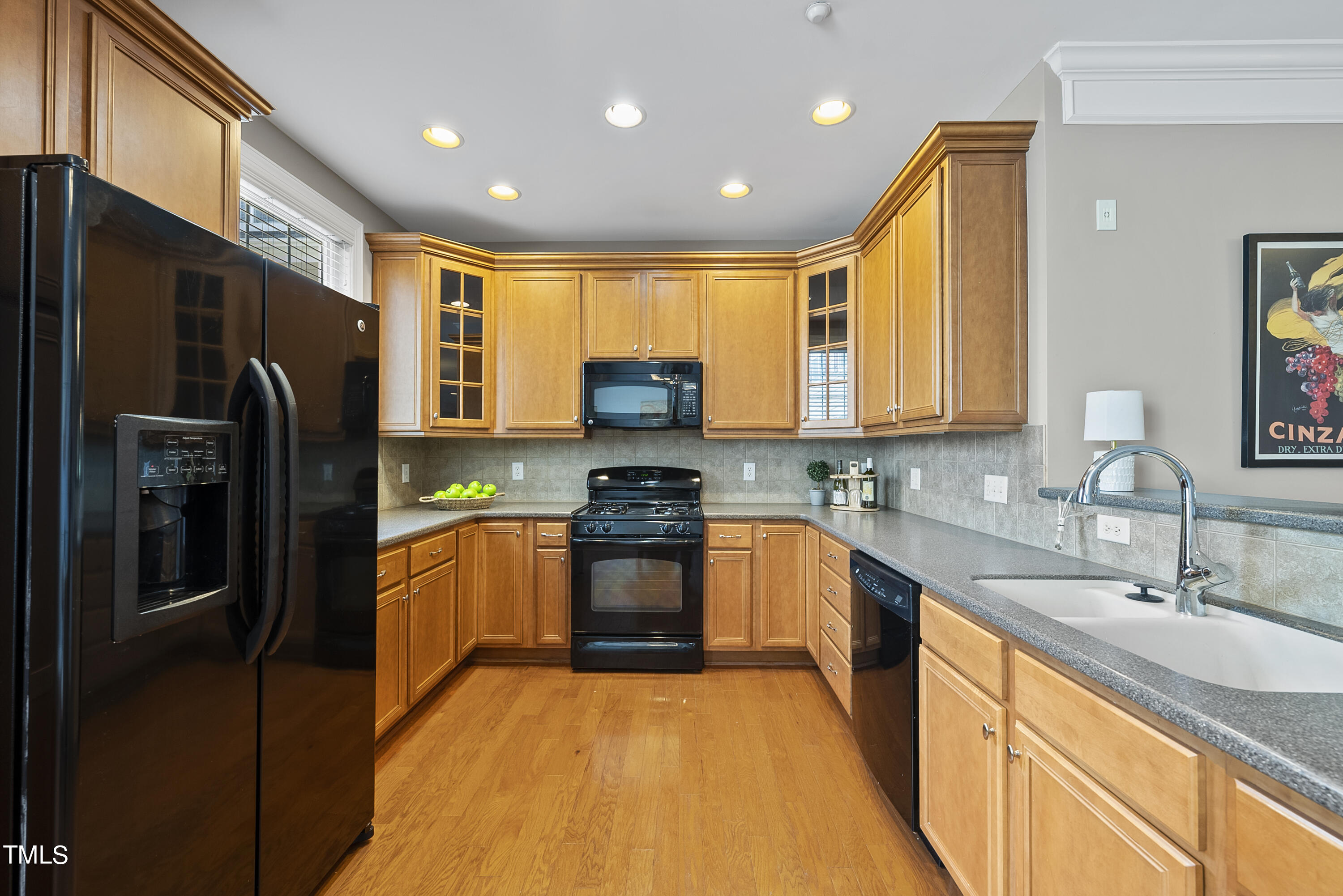 9221 Calabria Drive, Unit 109 Raleigh, NC 27617 - Photo 12 of 34 a kitchen with stainless steel appliances granite countertop a refrigerator a sink dishwasher a oven with large countertops