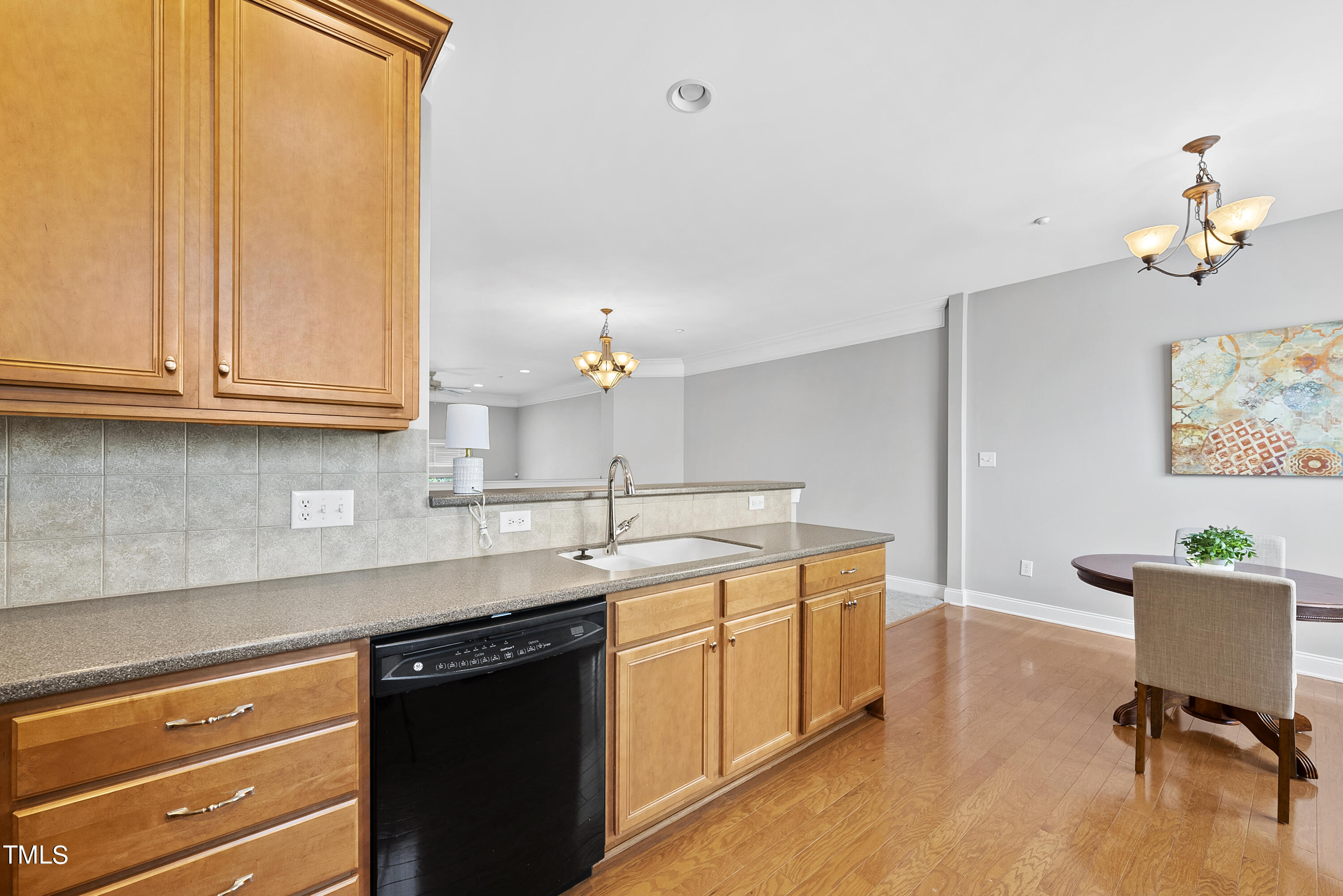 9221 Calabria Drive, Unit 109 Raleigh, NC 27617 - Photo 15 of 34 a kitchen with a sink cabinets and wooden floor