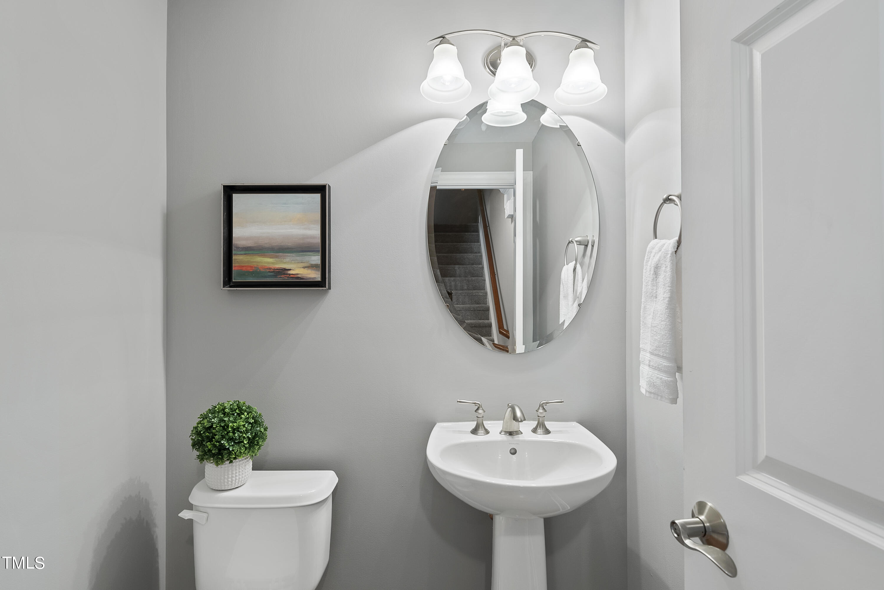 9221 Calabria Drive, Unit 109 Raleigh, NC 27617 - Photo 16 of 34 a bathroom with a sink mirror and toilet