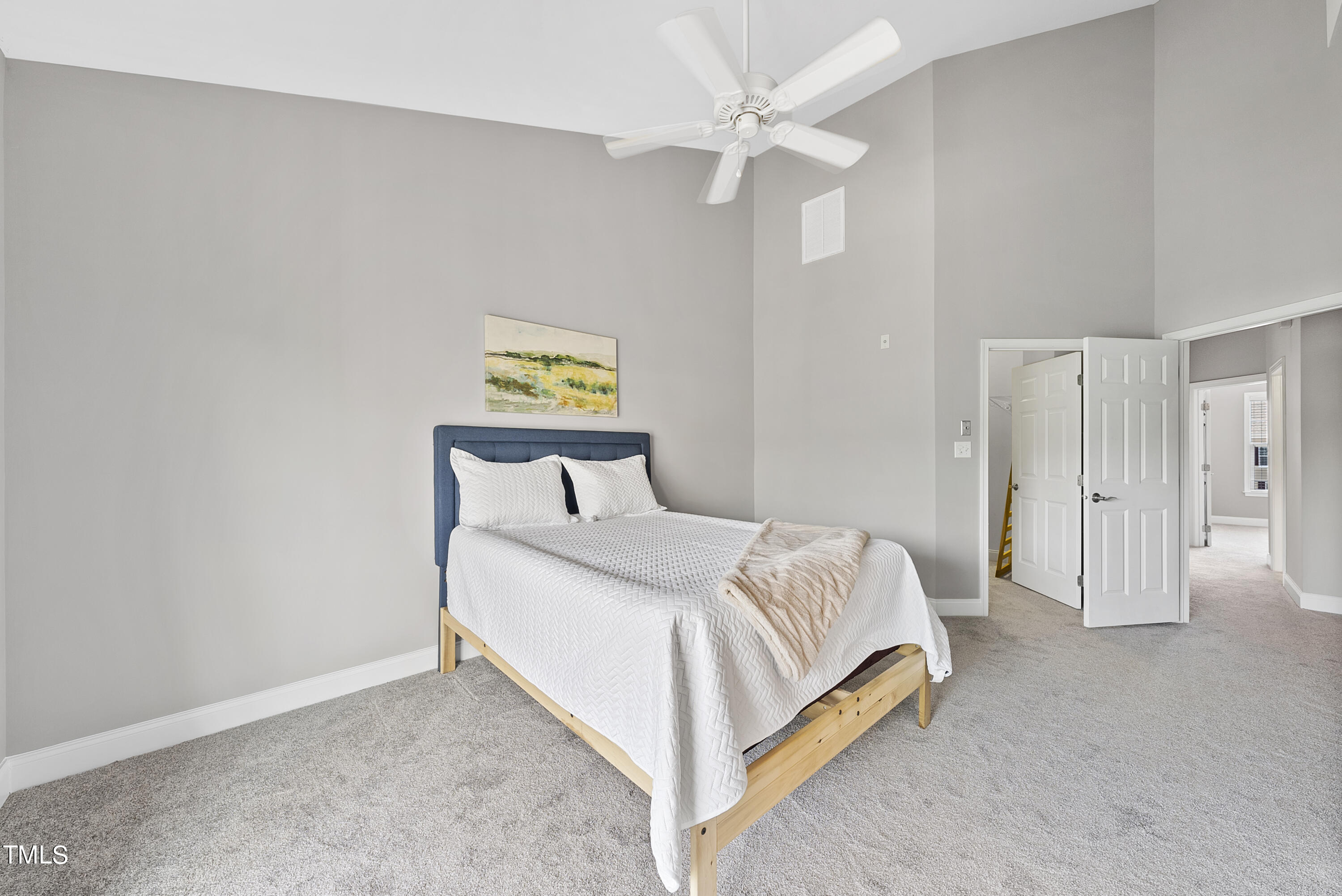 9221 Calabria Drive, Unit 109 Raleigh, NC 27617 - Photo 19 of 34 a bedroom with a bed and a chandelier