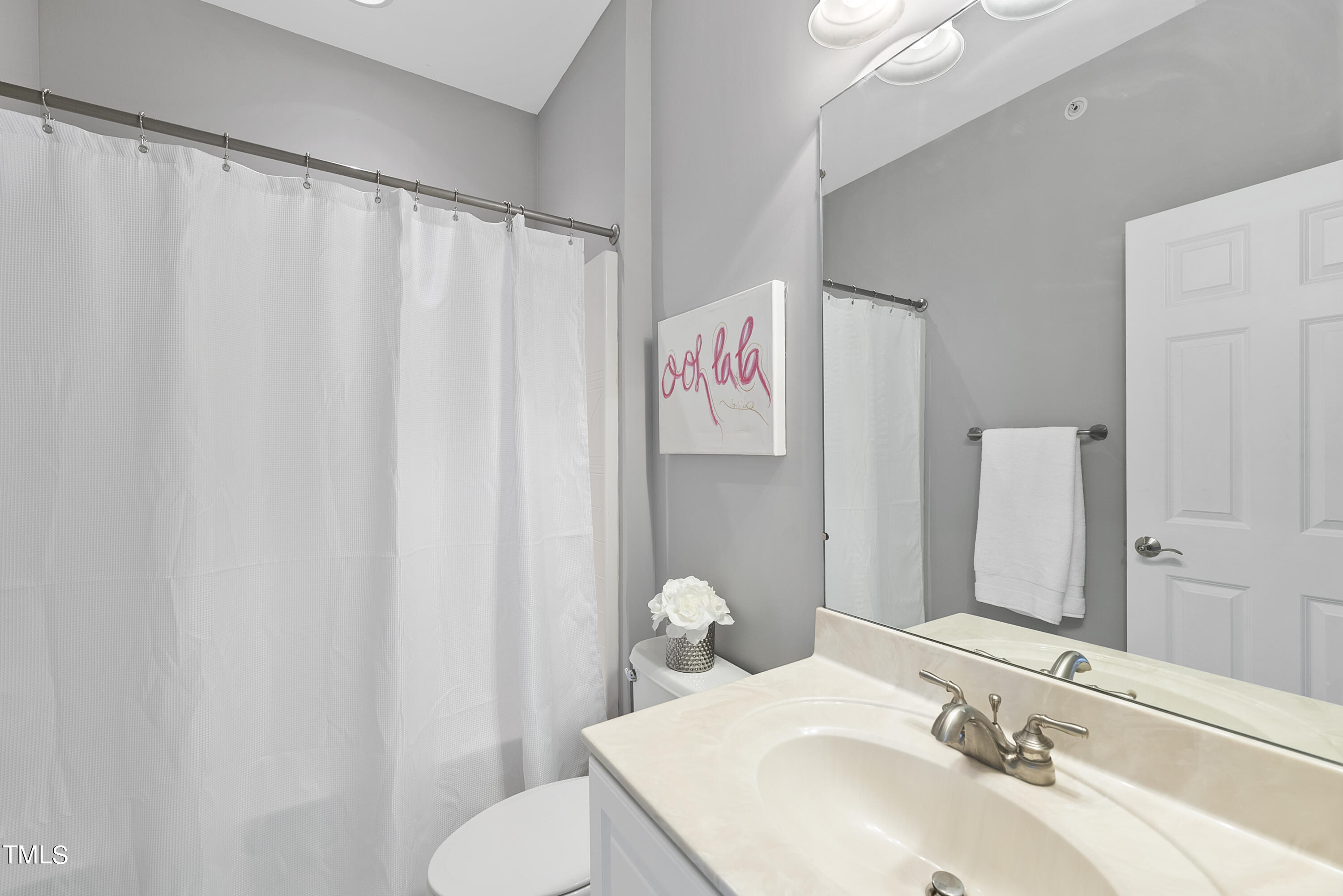 9221 Calabria Drive, Unit 109 Raleigh, NC 27617 - Photo 23 of 34 a bathroom with a sink and mirror
