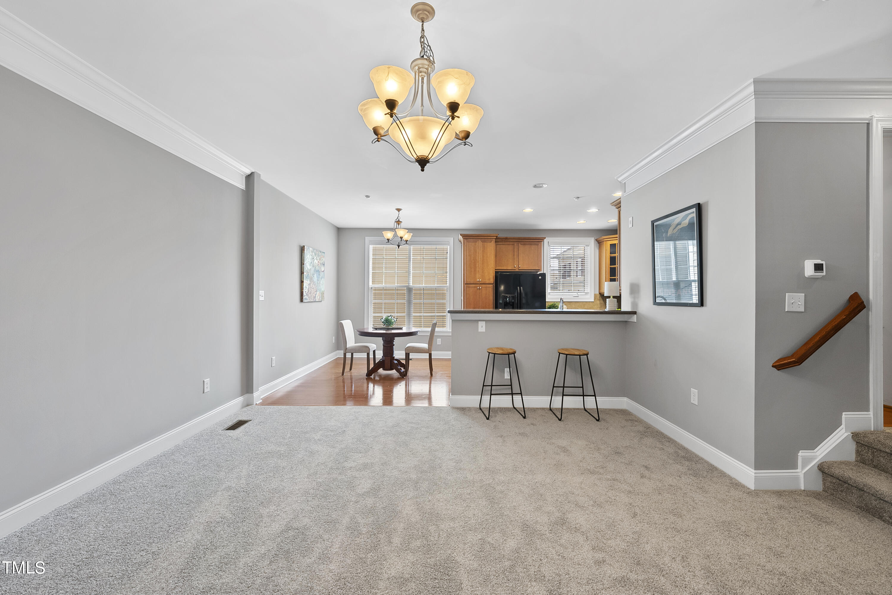 9221 Calabria Drive, Unit 109 Raleigh, NC 27617 - Photo 8 of 34 a view of a dining room with furniture and a chandelier