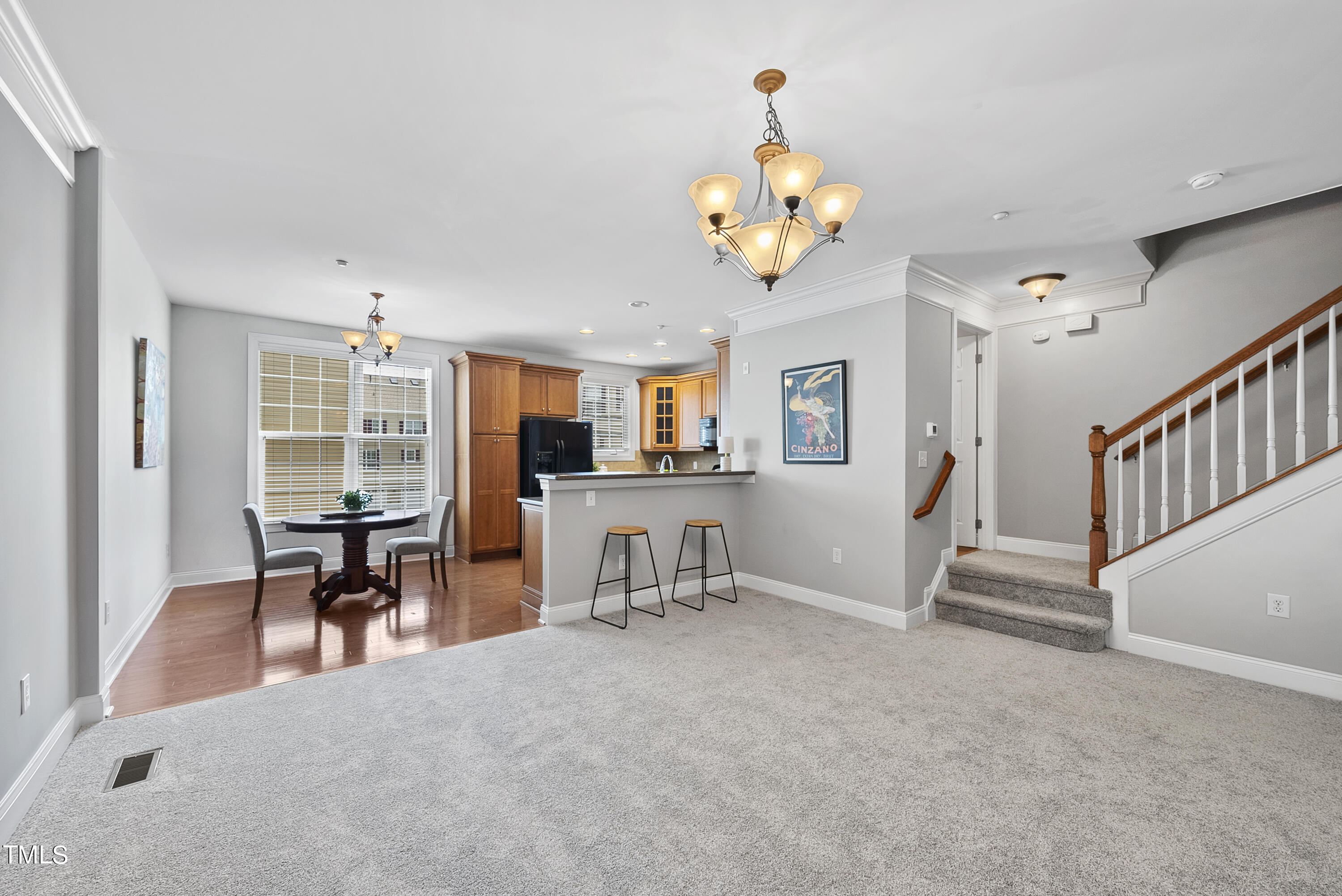 9221 Calabria Drive, Unit 109 Raleigh, NC 27617 - Photo 9 of 34 a view of a livingroom with furniture a flat screen tv and couches