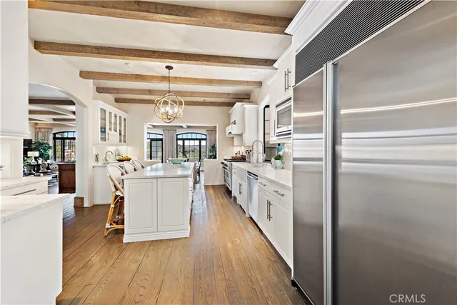 a large kitchen with a lot of counter space and stainless steel appliances