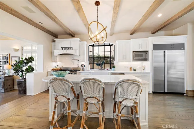 a large kitchen with stainless steel appliances kitchen island granite countertop a large island in the center