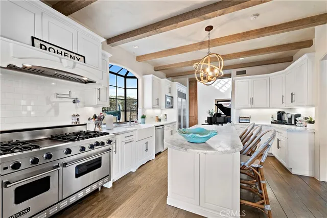 a dining room with wooden floor a glass table and chairs
