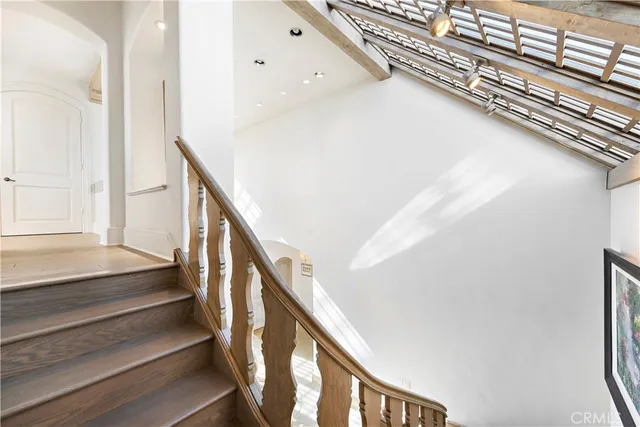 a spacious bedroom with a bed and large windows