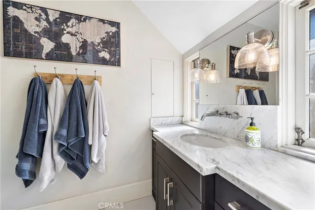 a bathroom with a sink double vanity and a mirror