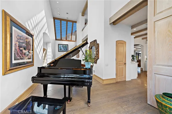 a kitchen with stainless steel appliances a lot of white cabinets and wooden floor