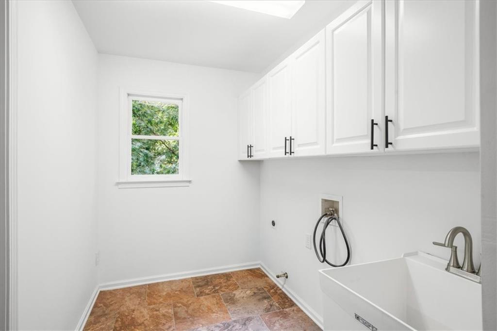 1710 Rising Mist Lane Cumming, GA 30041 - Photo 51 of 111 a bathroom with a sink and a window