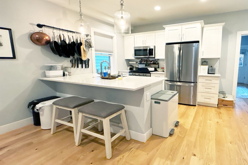 a kitchen with a sink cabinets and wooden floor