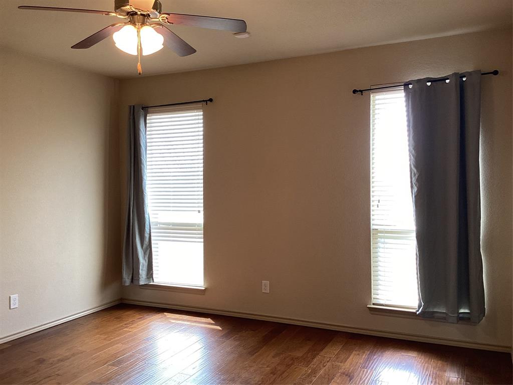 10213 Point Lobos Trail Fort Worth, TX 76177 - Photo 11 of 29 a view of an empty room with wooden floor and a window