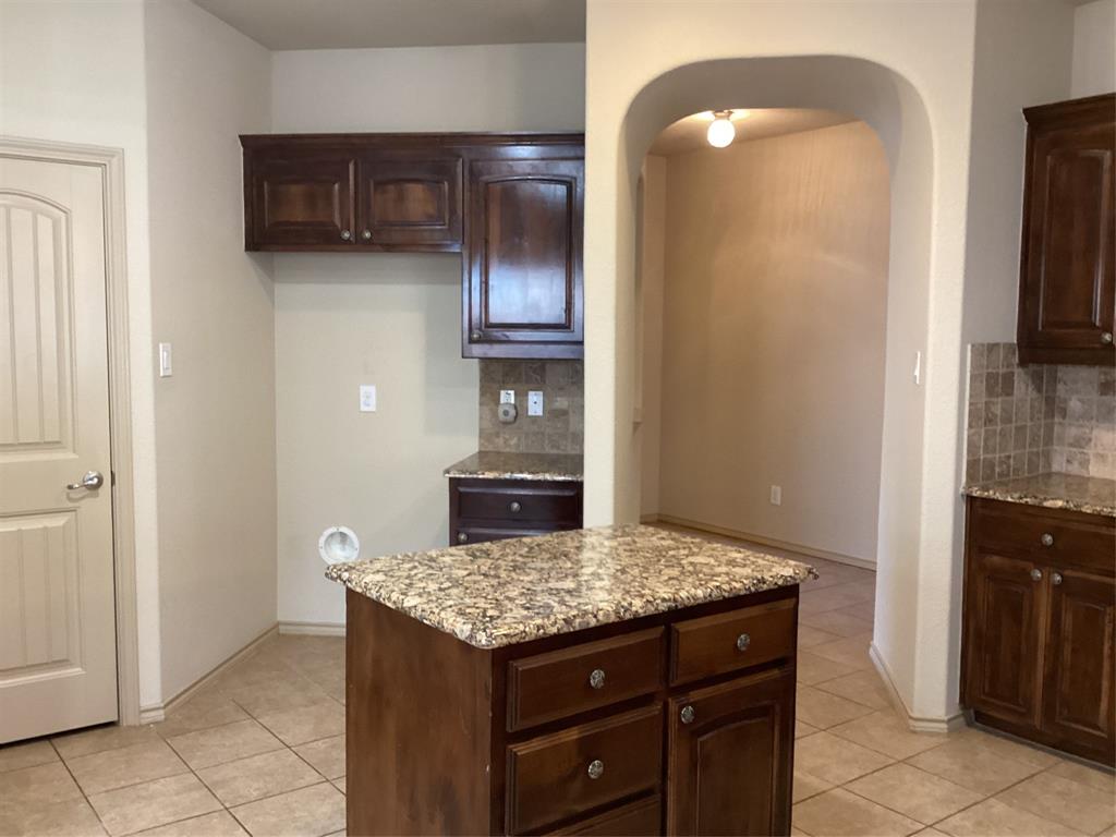 10213 Point Lobos Trail Fort Worth, TX 76177 - Photo 8 of 29 a kitchen with a granite countertop refrigerator a sink and a stove