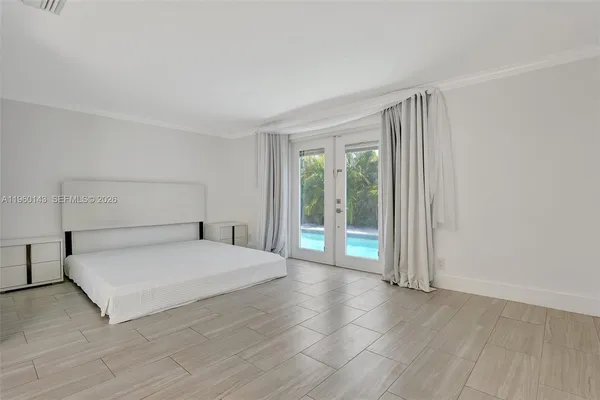 a spacious bedroom with a bed and a window