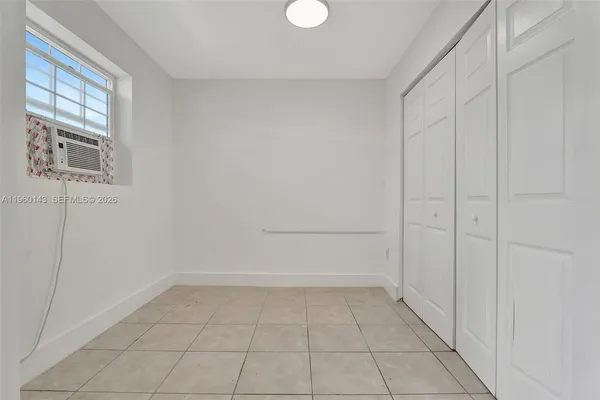 an empty room with closet area