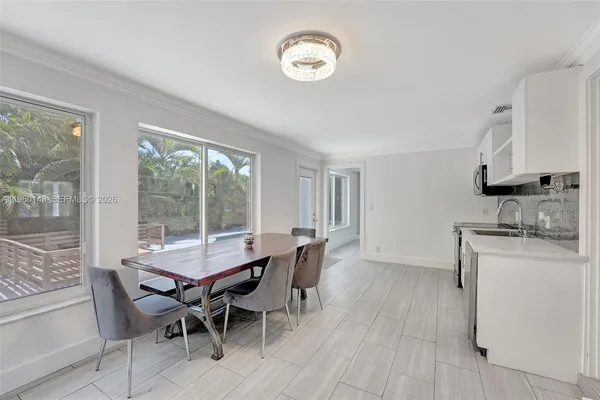 a view of a dining room with furniture window and outside view