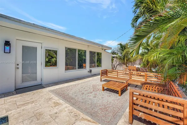 a view of a backyard with sitting area