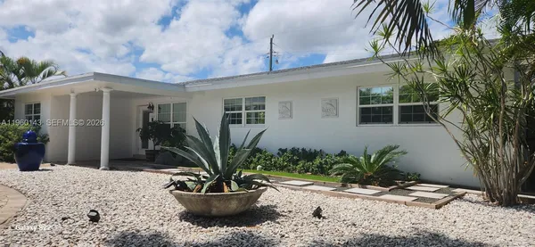 a view of a livingroom with furniture and a flat screen tv