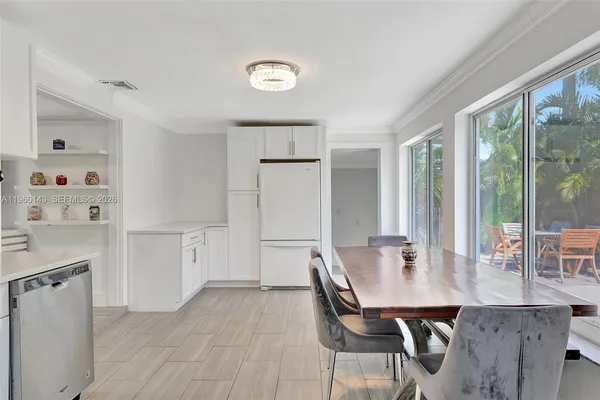 a view of a dining room with furniture and window