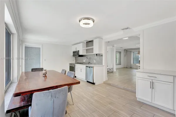 a kitchen with a table and chairs