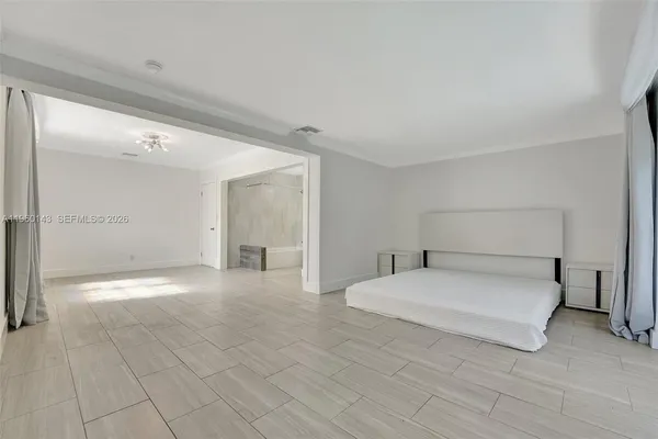 a large white bed in a white room