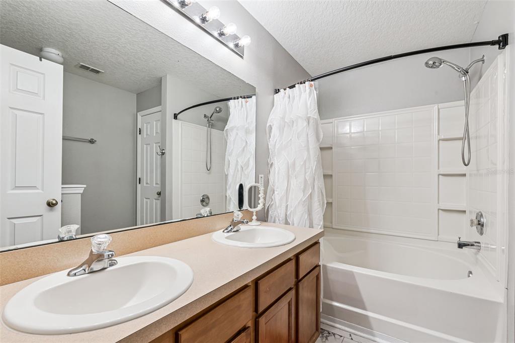 2523 Martins Run Tavares, FL 32778 - Photo 13 of 21 a bathroom with a sink double vanity mirror and a bathtub